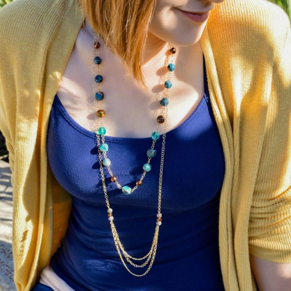 woman wearing long blue jasper necklace
