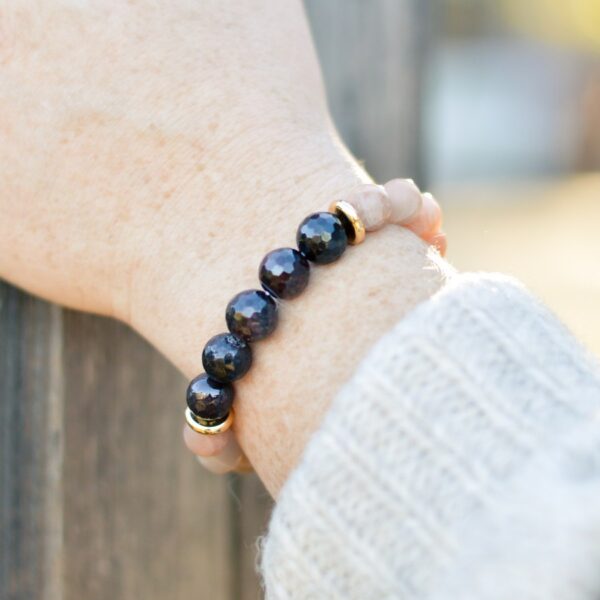 woman wearing sunstone and garnet bracelet